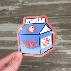 hand holding a die cut sticker printed on vinyl sticker paper